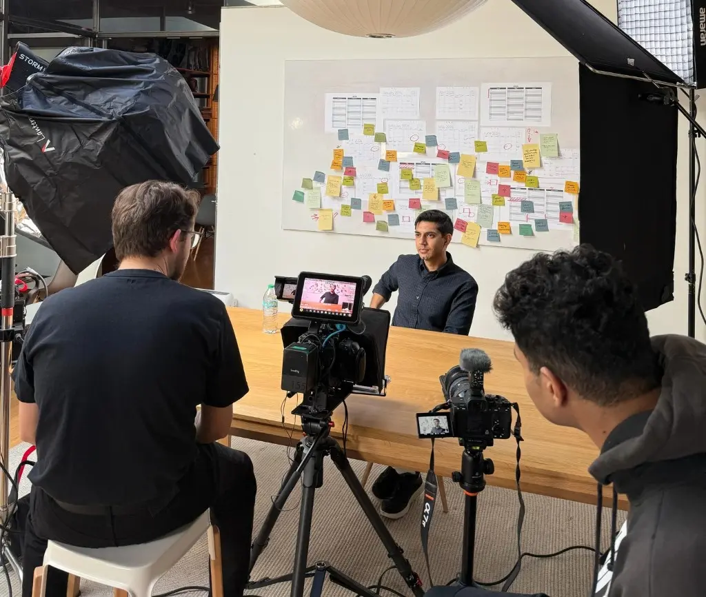 Represent crew filming an interview on set in a San Francisco office