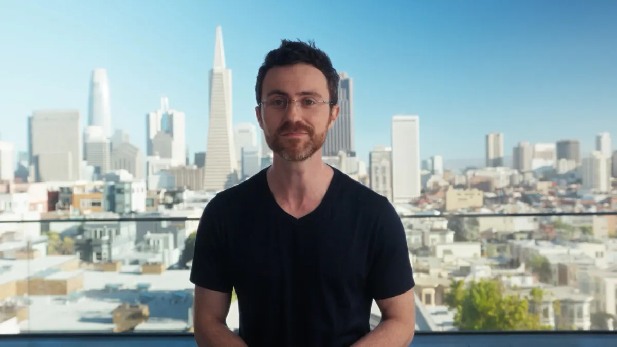 Represent team member on a rooftop overlooking the San Francisco skyline